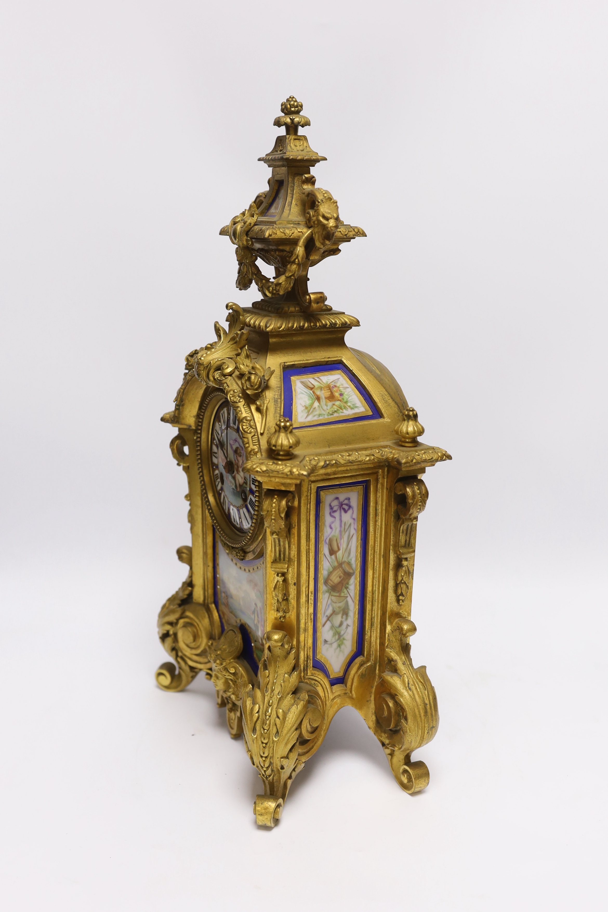 A Sevres style ormolu clock, Miller & Sons with two similar gilt spelter urns, pendulum no key, 44cm